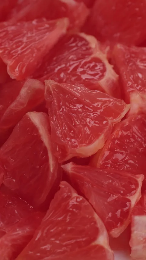 Chopped fresh red grapefruit close up, rotation Video stock 301907923