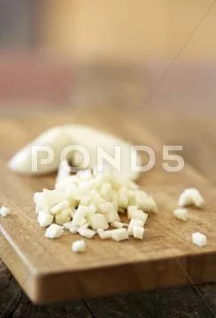 Chopped Garlic On Chopping Board