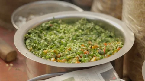 Chopped green chili mixture in large bowl prepared for Indian snack at street Stockbeeldmateriaal 333427412
