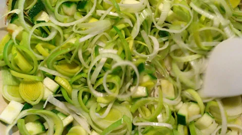 Chopped leeks and zucchini stewing in the pan Stock Footage 35661180