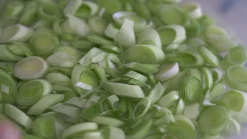 Chopped leeks for cooking are washed in a bowl, Stock Footage 256582334