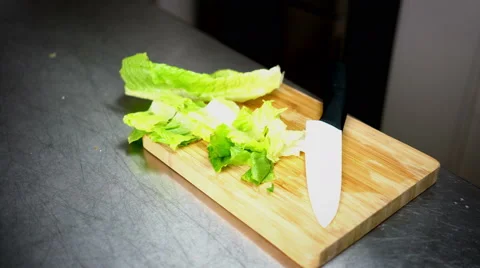 Chopped Lettuce on Cutting Board with Ceramic White Knife - 4K Resolution Stock Footage 59786054