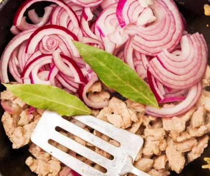 Chopped meat is fried in a pan Stock Photos
