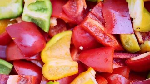 Chopped multi-colored Bell Pepper falls slowly. Slow motion Stock Footage