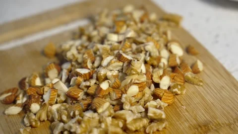 Chopped nuts on wooden board 動画素材 320660985