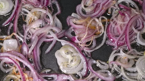 Chopped onion fried in a pan, close-u Stock Footage 87614509