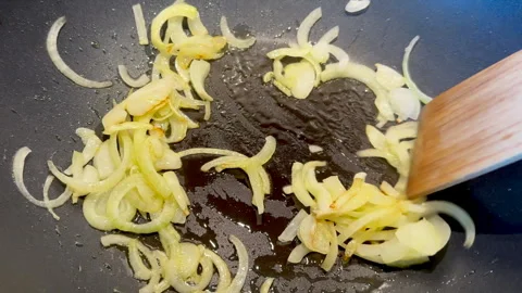 Chopped onions are fried in a pan Stock Footage 247608939