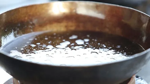 Chopped onions are fried in a pan close-up Stock Footage 248538449