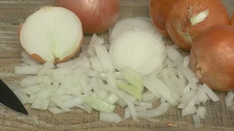 Chopped Onions Carefully Placed on a Rustic Wooden Cutting Board for Cooking Stockbeeldmateriaal 282665308
