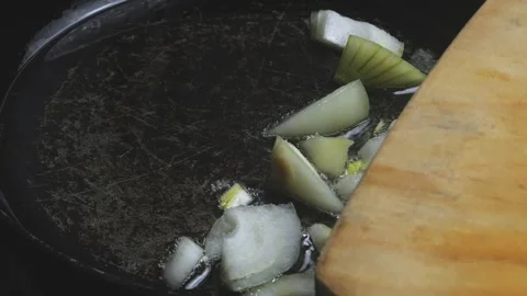 Chopped onions fall into a frying pan with boiling oil and fry Video stock 309138631