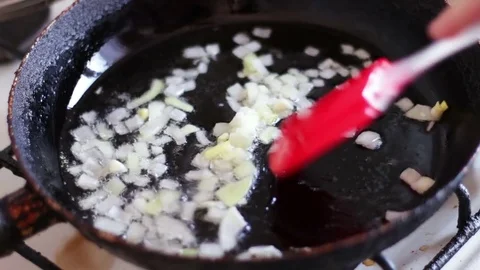 Chopped onions fried in vegetable oil in the pan Stock Footage