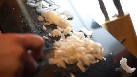Chopped onions into pan Video stock 101890633
