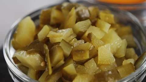 Chopped pickles in a bowl close up, preparing the sauce. Stock Footage 321943966