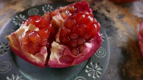 Chopped pomegranate rotating on a table Stock Footage 165340731