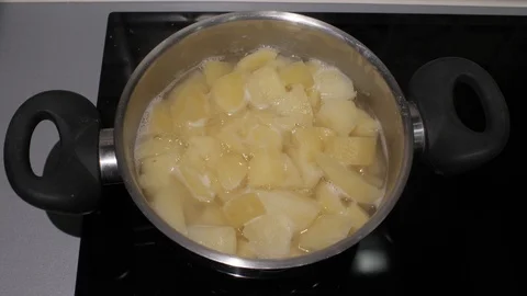 Chopped potatoes are boiled in a pan on an electric stove.boiled potatoes. 4k Stock Footage 114703847