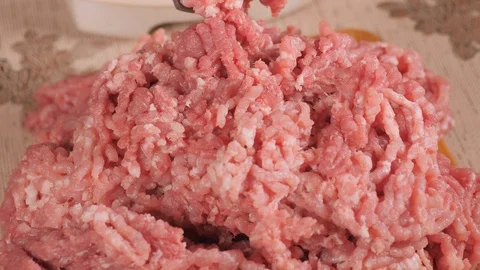 Chopped raw meat. The stuffing is on the Board. Hands squeeze the semi-finished  Stock Footage 122589400