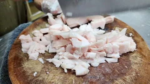 Chopped Raw Pork Fat Pieces on a Rustic Round Wooden Cutting Board Stock Photos