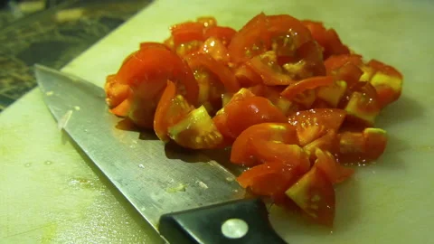 Chopped up red tomatoes along with knife in a chopping board Stock Footage 256732728