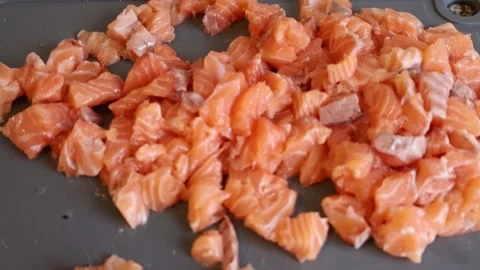 Chopped salmon pieces on a kitchen table. Seafood preparation Stock Footage 232005171