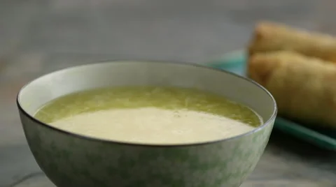 Chopped spring onion falling in soup Video stock 46668336