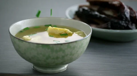 Chopped spring onion falling in soup Stock Footage 46668746