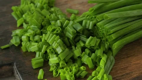 Chopped spring or green onion on wooden cutting board Stock Footage 226138877