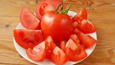 Chopped tomato on a plate. Video stock 246781430