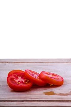 Chopped tomatoes on chopping board Stock Photos