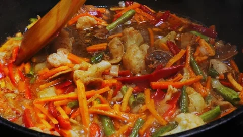 Chopped vegetables are stewed in a frying pan in boiling oil Stock Footage 304517995