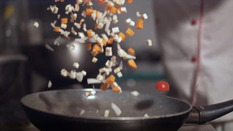 Chopped vegetables falling in a pan Stock Footage 86465702