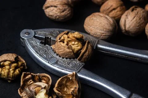 Chopped walnuts on a black background. Stock Photos