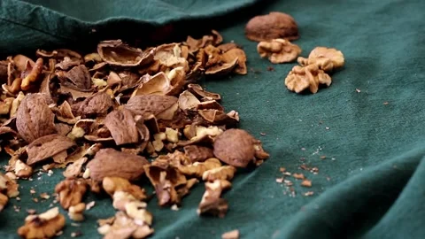 Chopped walnuts, shell and nutcracker on the table Stock Footage 232617972