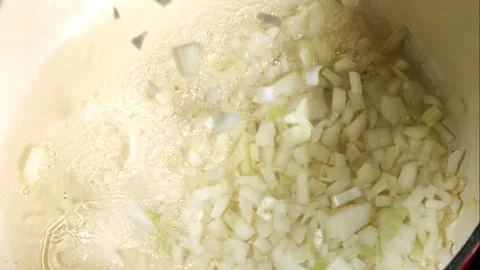 Chopped White Onions Falling Into A Hot Pot Of Sizzling Oil Stock Footage 326291673