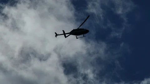 Chopper flying in blue sky with clouds 動画素材 119864650
