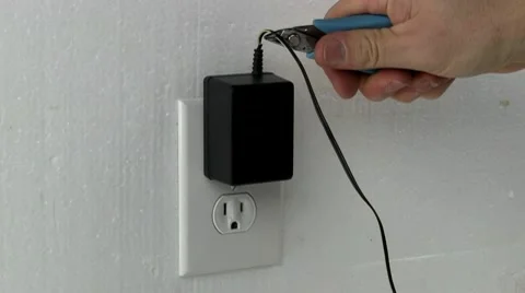 Chopping AC/DC wall adapter with cutters Stock Footage 10592034