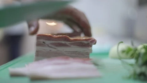 Chopping Bacon in Thin Slices Stock Footage 129335937