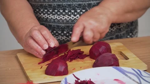 Chopping beetroot into thin slices for cooking Ukrainian borscht Stock Footage 328373047