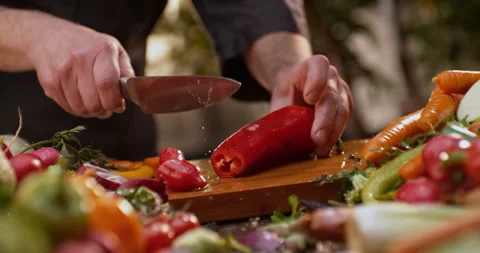 Chopping bell pepper in kitchen Stock Footage 311833046