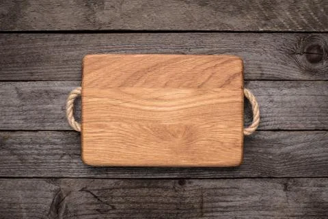 Chopping board on rustic table Stock Photos