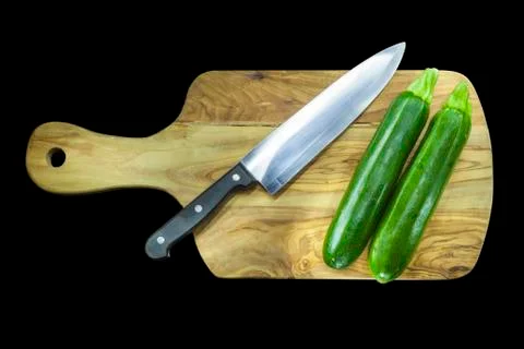 Chopping board with two courgettes Stock Photos