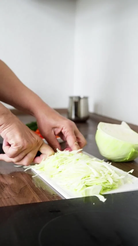 Chopping Cabbage A Culinary Delight in Action is a rewarding experience for Stock Footage 316101021