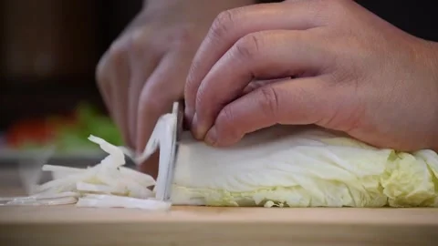 Chopping cabbage for fresh salad preparation at kitchen 스톡 동영상 320198822