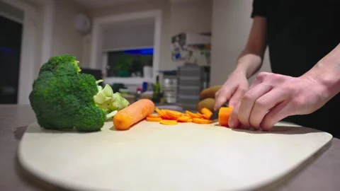 Chopping a carrot in a modern kitchen Stock Footage 158851793