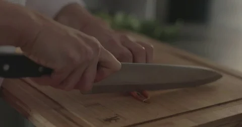 Chopping carrots on a cutting board Stock Footage 76405717