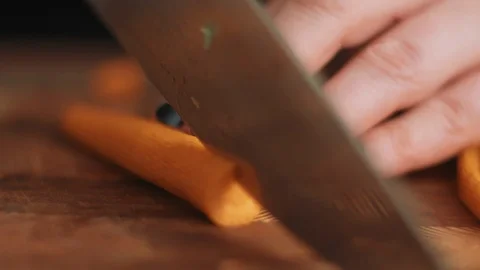 Chopping Carrots on a Cutting Board Stock Footage 86161968
