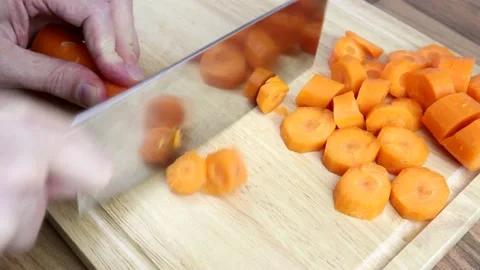 Chopping Carrots With A Large Kitchen Knife 스톡 동영상 134345473