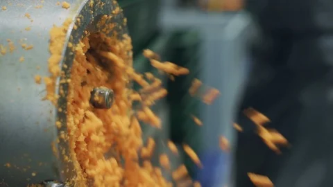 Chopping Carrots in a vegetable processing plant. Modern plant for carrot Stock Footage 129264903