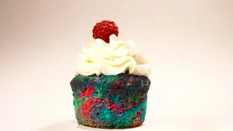 Chopping cupcake on white background. Stock Footage 136899932