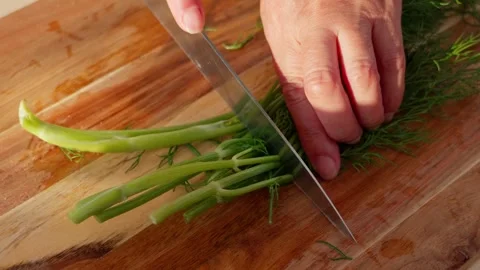 Chopping dill with a knife Stock Footage 326908285