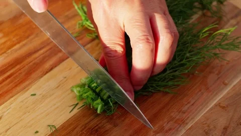 Chopping dill with a knife Stock Footage 326908473
